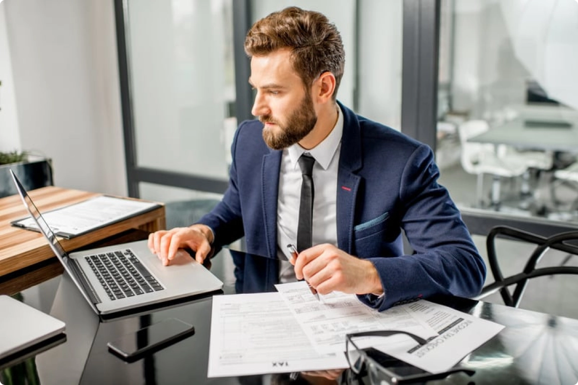 A CPA reviewing financial documents and reports