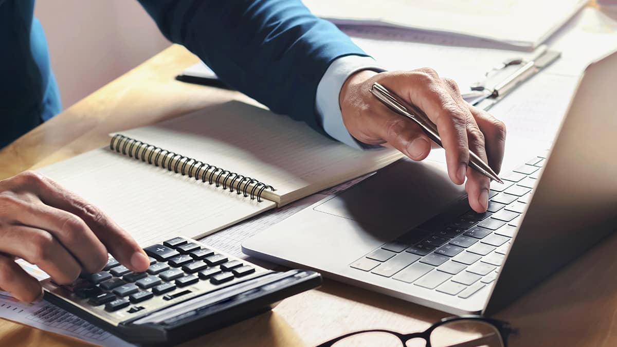 An accountant processing payroll with a calculator